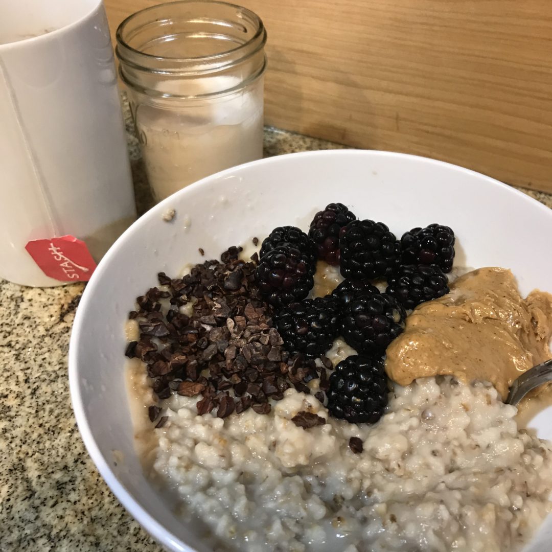 Steel cut oats with peanut butter, berries, and cacao nibs